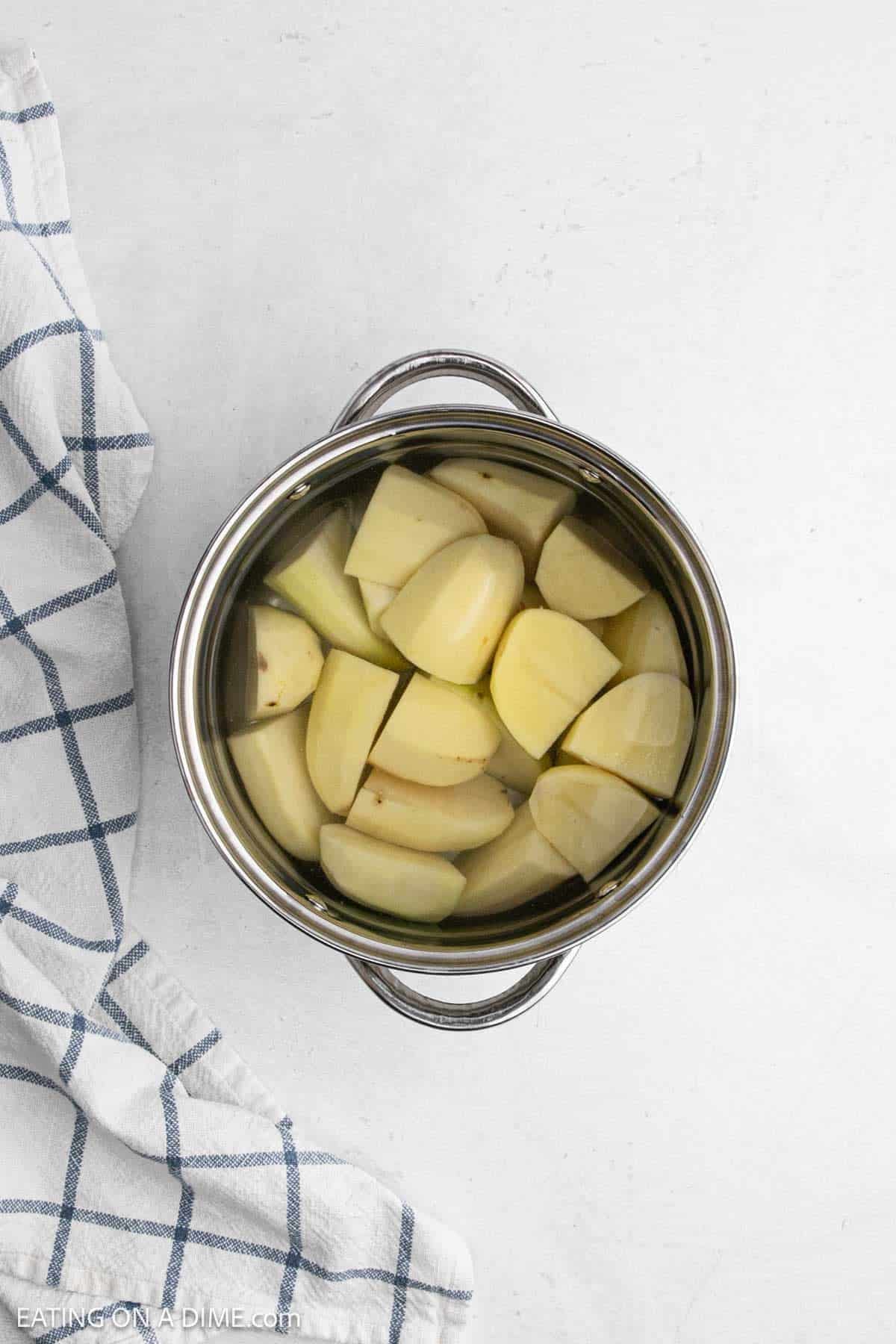 Peeled and cut potatoes in a large pot of water.