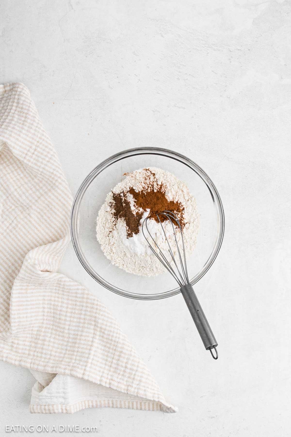 Combining the dry ingredients in a bowl with a whisk.