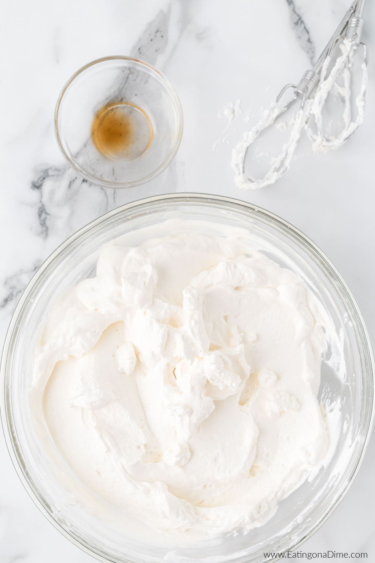 Cream and vanilla mixed together in a bowl.