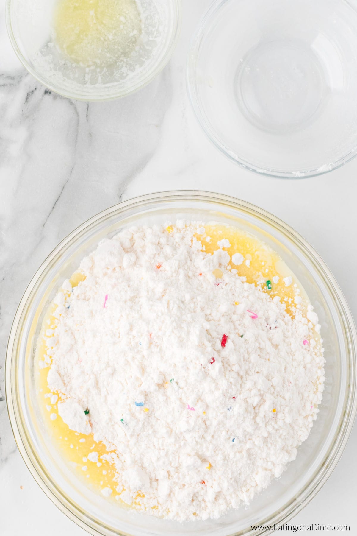 Cake mix, milk and butter mixed together in a bowl.
