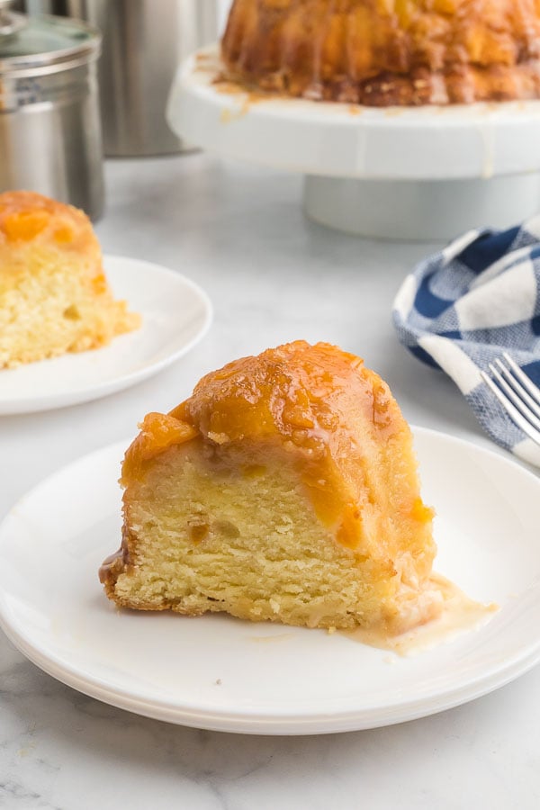 Slice of Peach Cobber Pound Cake on a white plate