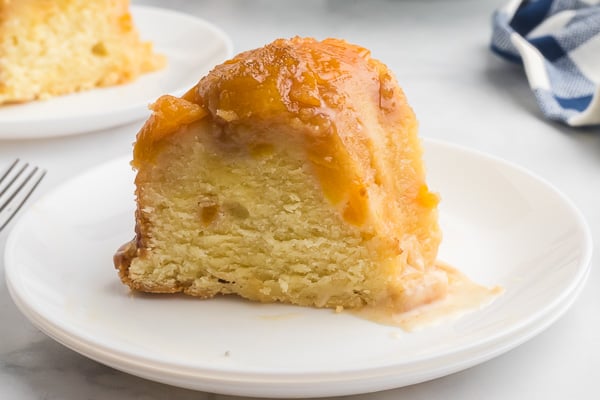 Slice of Peach Cobber Pound Cake on a white plate