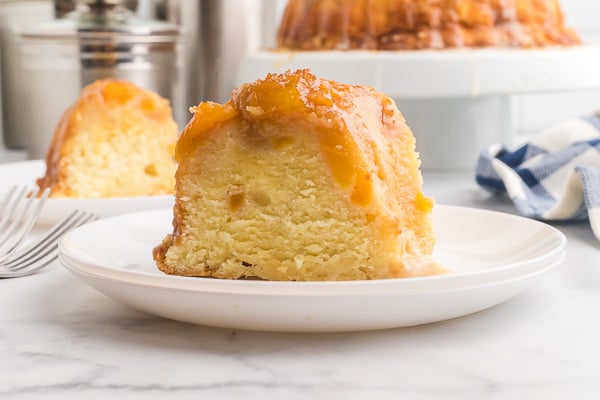 Slice of Peach Cobber Pound Cake on a white plate