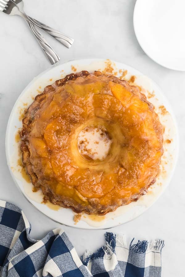 A whole peach clobber pound cake on a plate