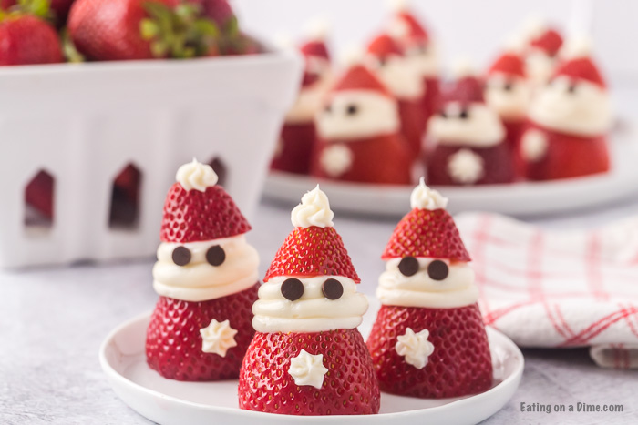 Close up image of Strawberry Santas on a white plate. 