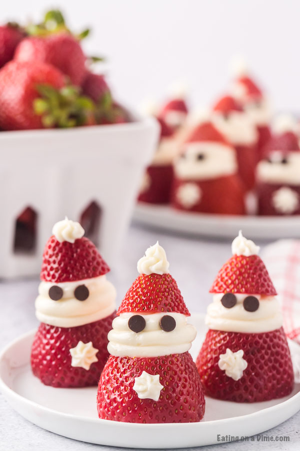 Close up image of Strawberry Santas on a white plate. 