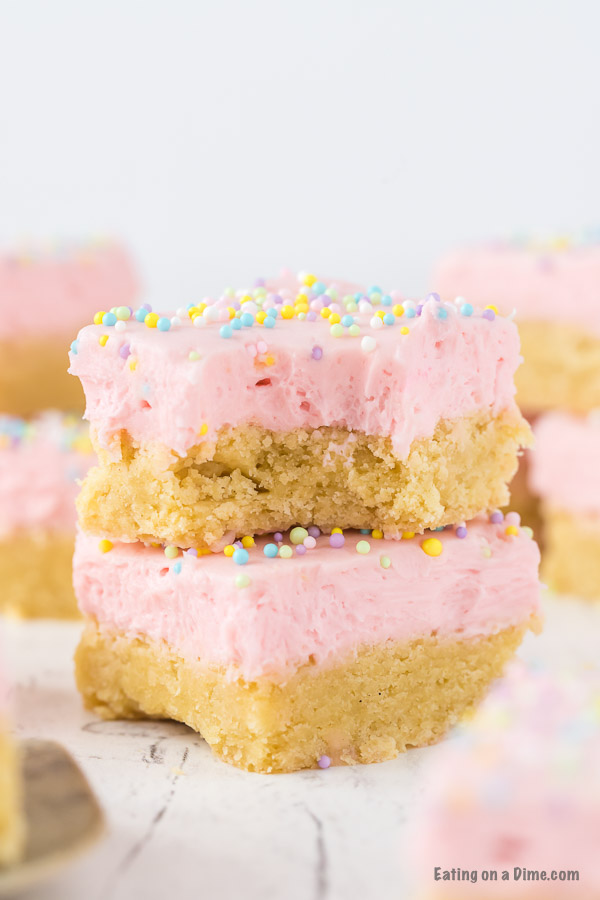 Close up image of sugar cookie bars frosted stacked