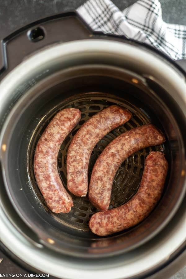Brats in the air fryer basket. 