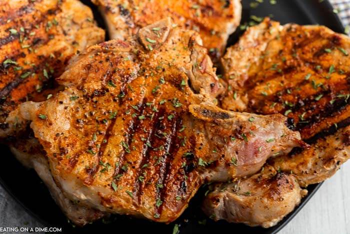Grilled bone in pork chops on a plate.