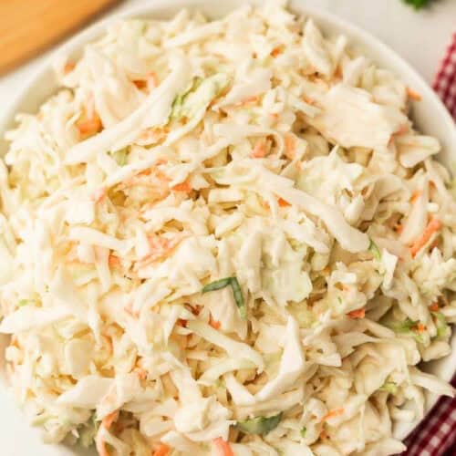 Close up of coleslaw in a white bowl.