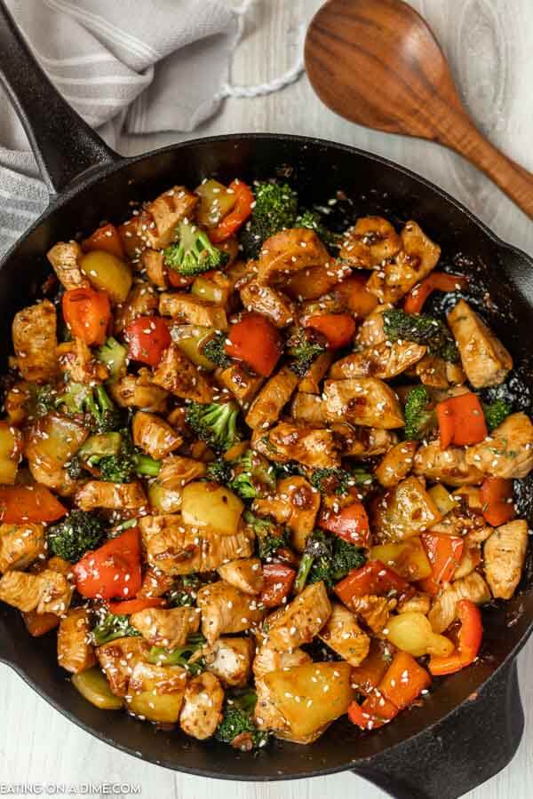 Chicken Stir Fry in a skillet with a wooden spoon. 