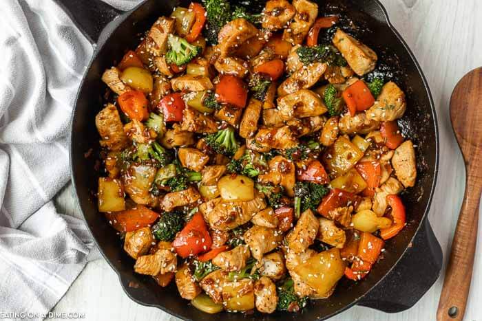 Chicken Stir Fry in a skillet with a wooden spoon. 