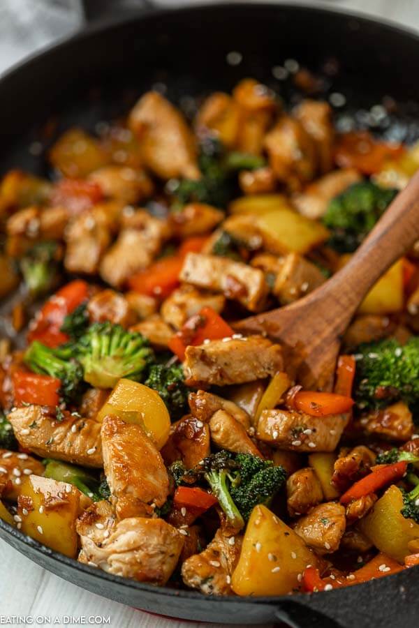 Chicken Stir Fry in a skillet with a wooden spoon. 