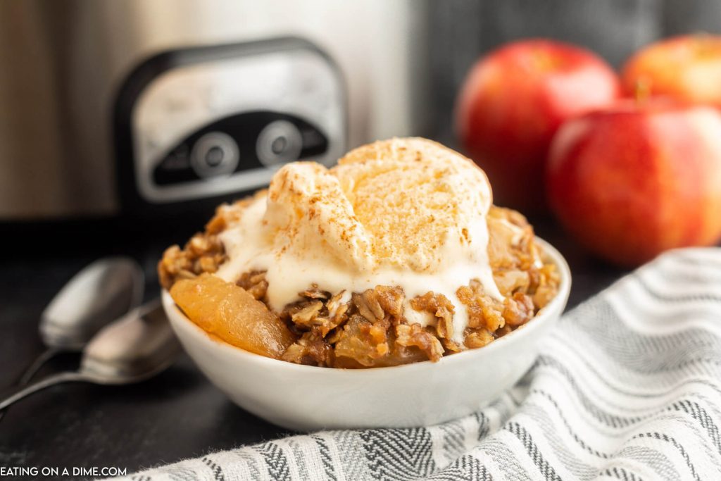 Apple Crisp in a bowl topped with vanilla ice cream