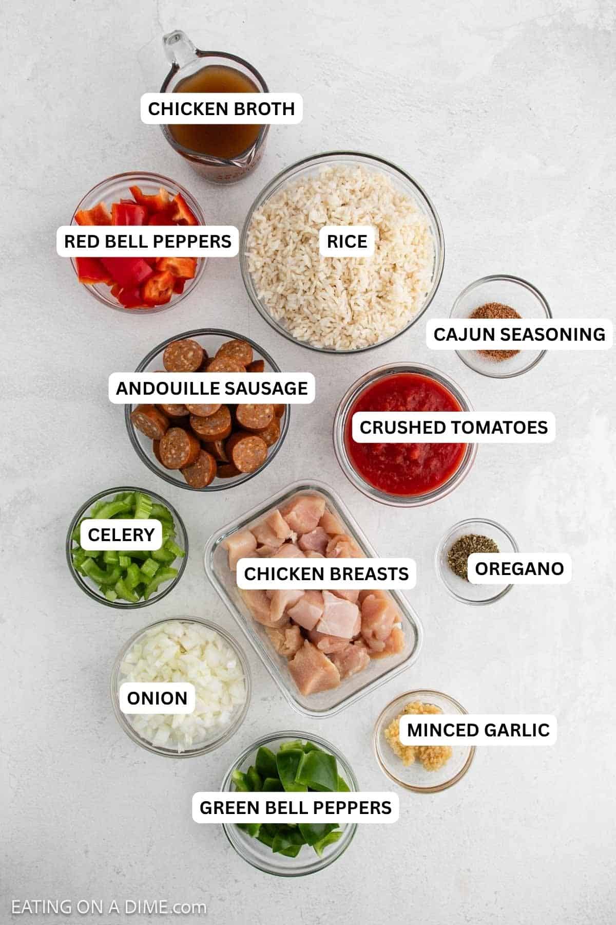 Ingredients for recipe: chicken broth, bell peppers, rice, Cajun seasoning, andouille sausage, crushed tomatoes, celery, chicken breasts, oregano, onion, minced garlic and green bell peppers.