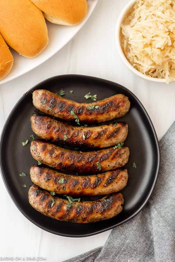 Grilled brats on a plate.