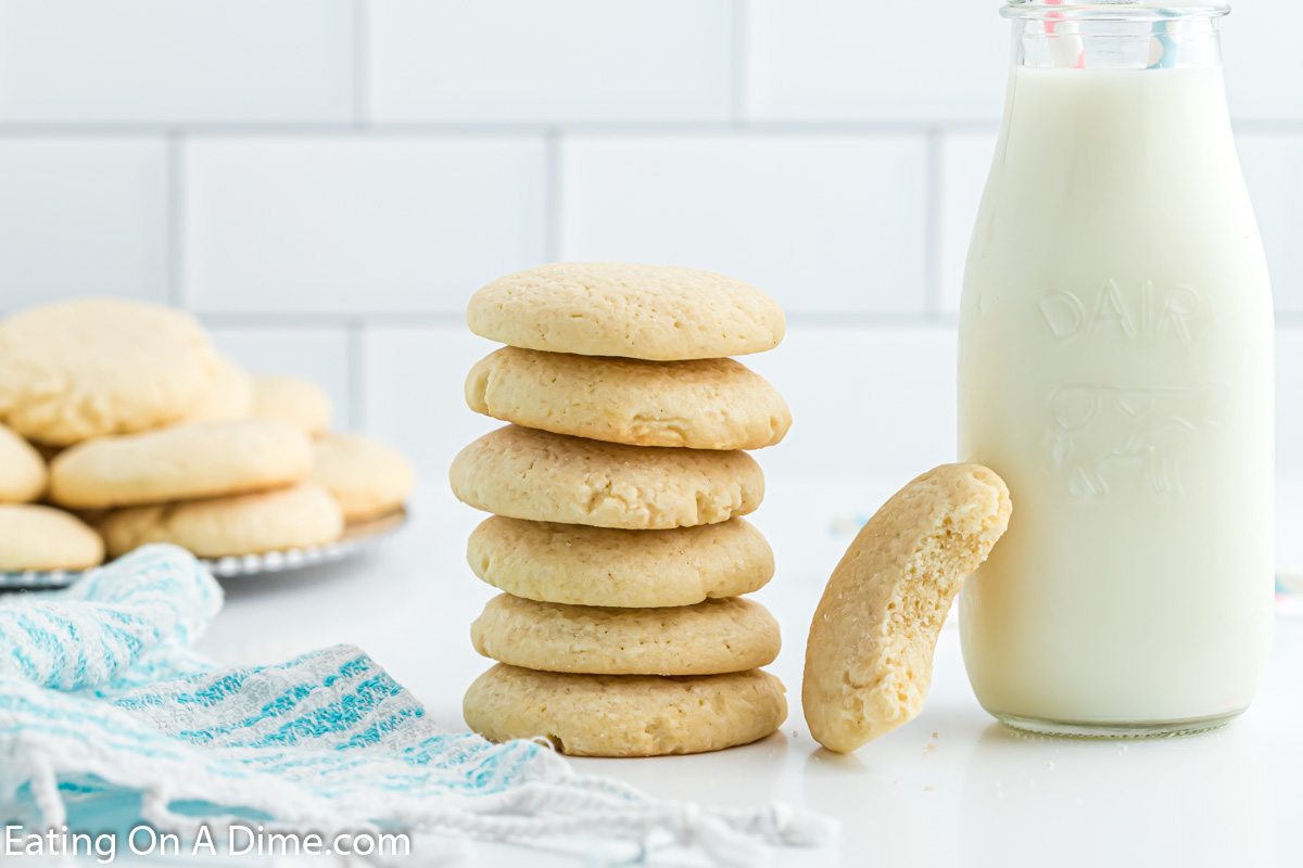 Sugar Cookies stacked with a jug of milk
