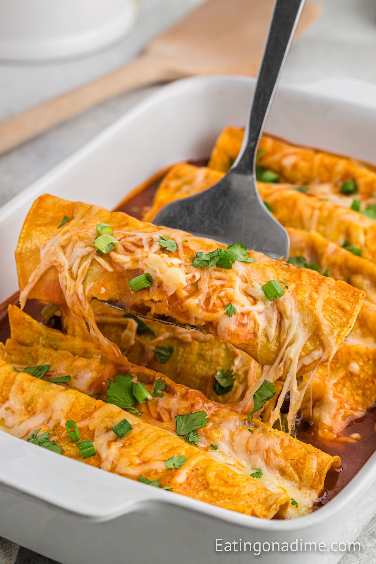 Bean and Cheese Enchiladas in a white casserole dish. 