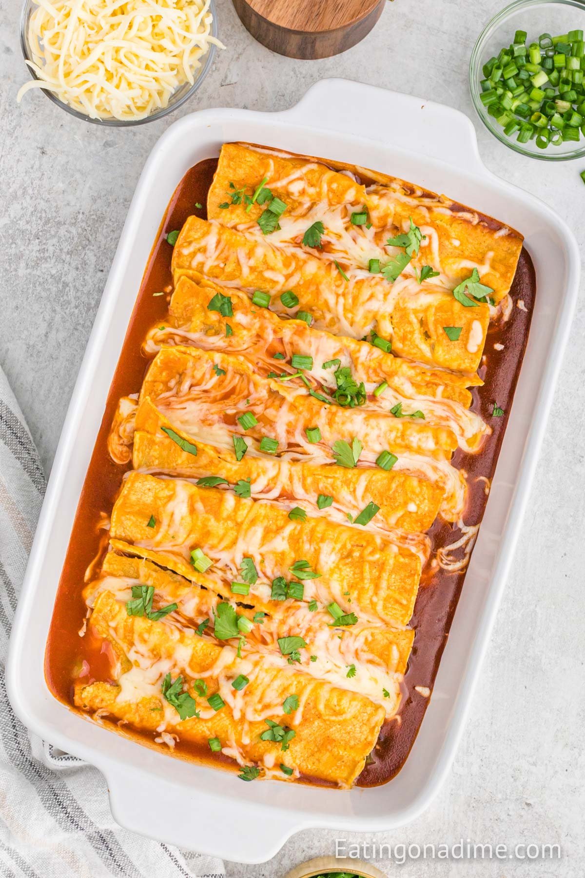 Bean and Cheese Enchiladas in a white casserole dish. 