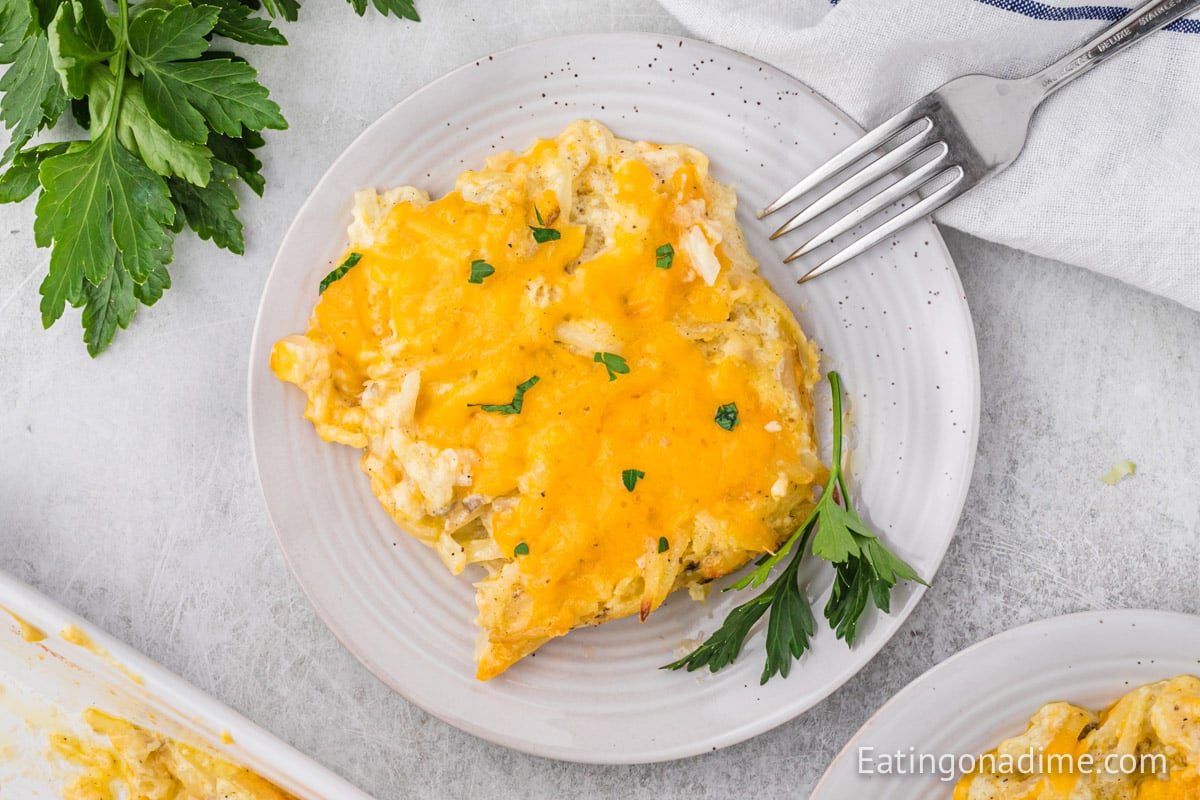 cheesy hashbrown casserole on a white plate