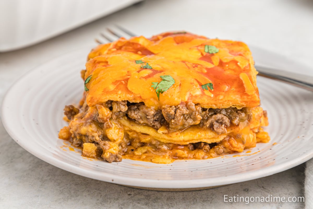 A close up image of beef enchilada casserole on a plate