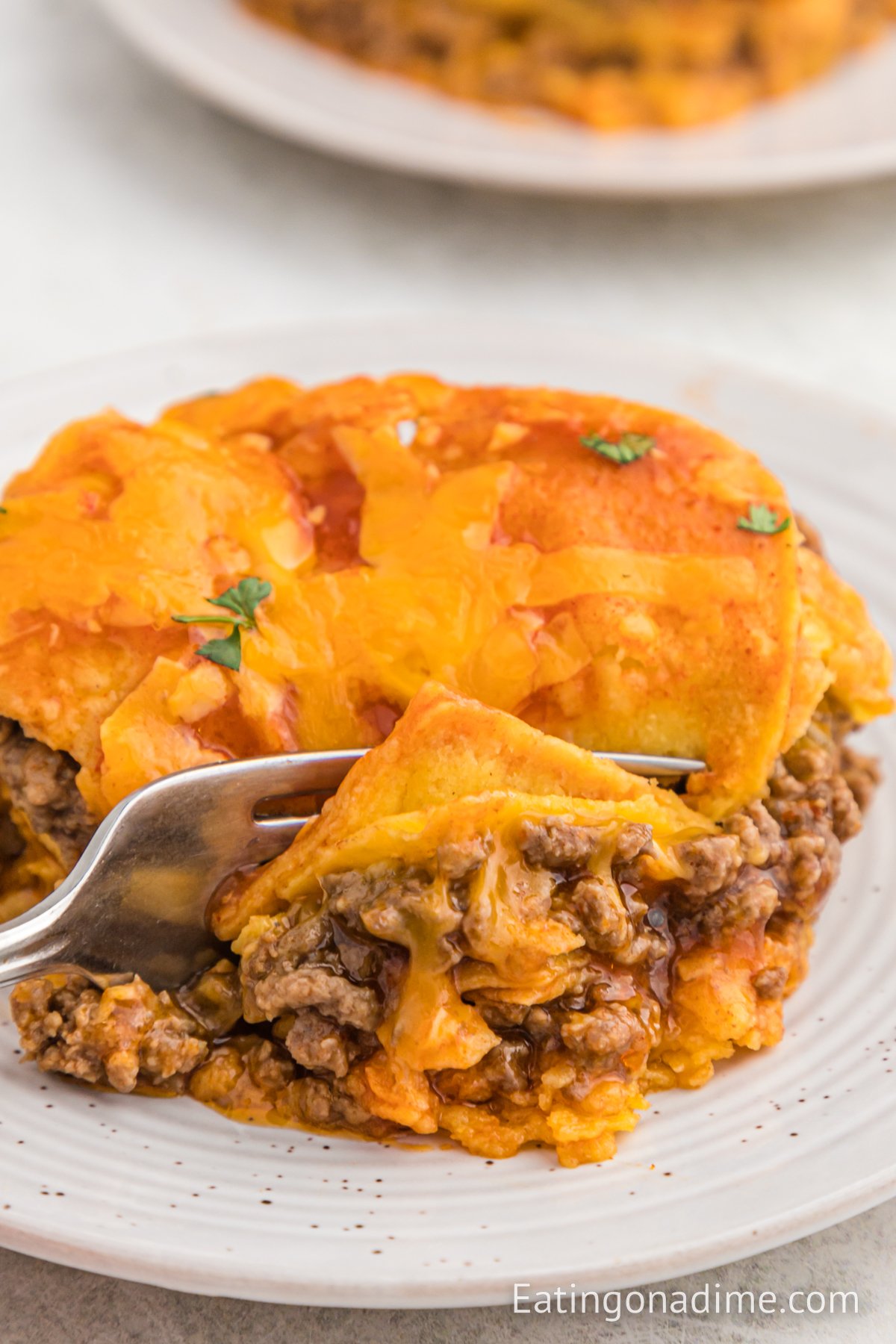 A close up image of beef enchilada casserole on a plate