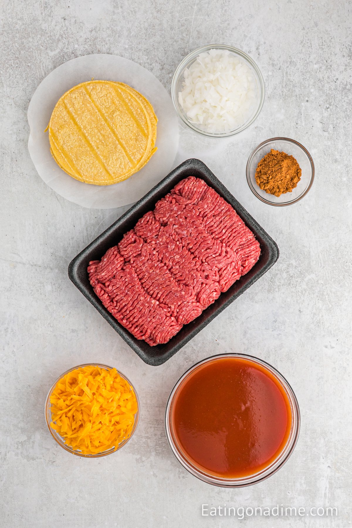 Ingredients needed - ground beef, onion, taco seasoning, red enchilada sauce, corn tortillas, cheddar cheese, cilantro