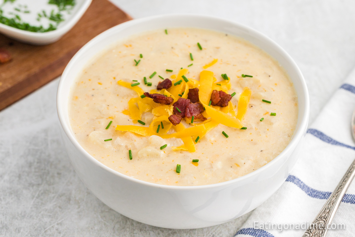 Bowl of Paula Deen potato soup topped with cheese and bacon. 