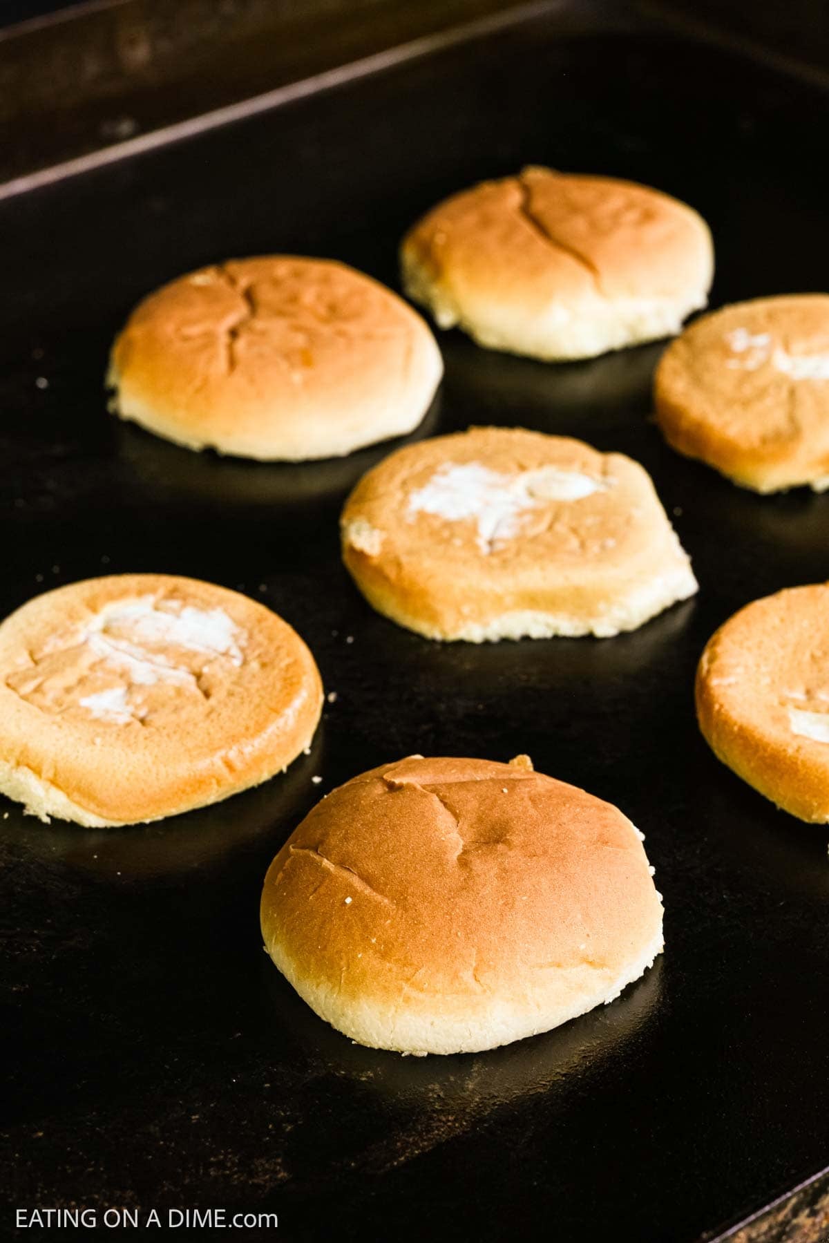 Hamburger buns on the flat top griddle.