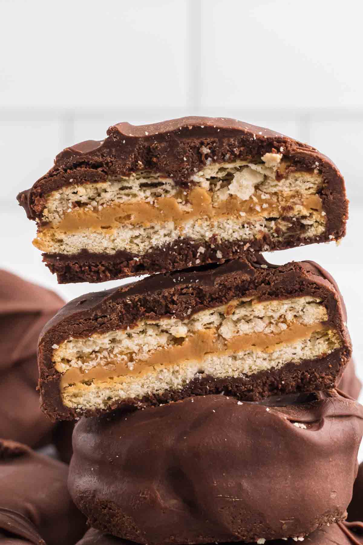 Chocolate Covered Ritz Crackers stacked with one one cut in half