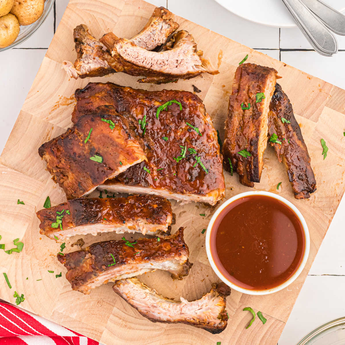 Crock pot ribs with coke on cutting board. 