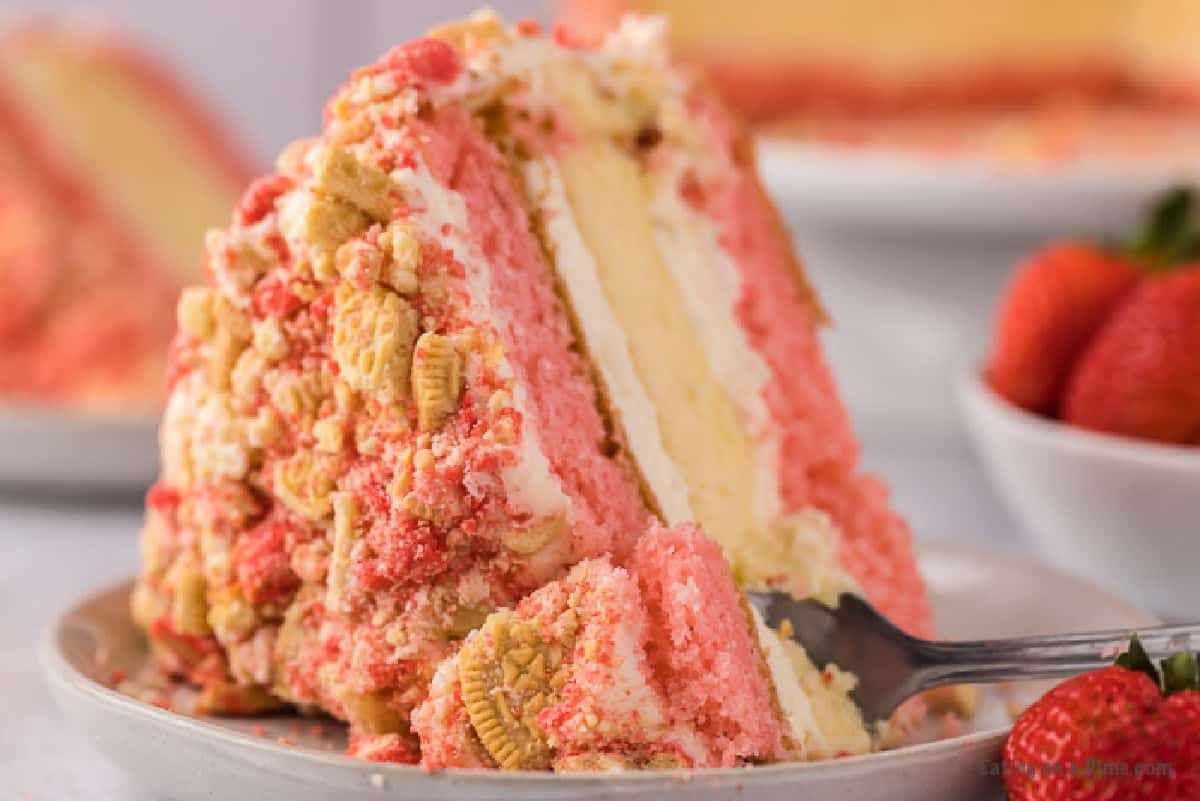 Slice of cheesecake with strawberries on a plate.