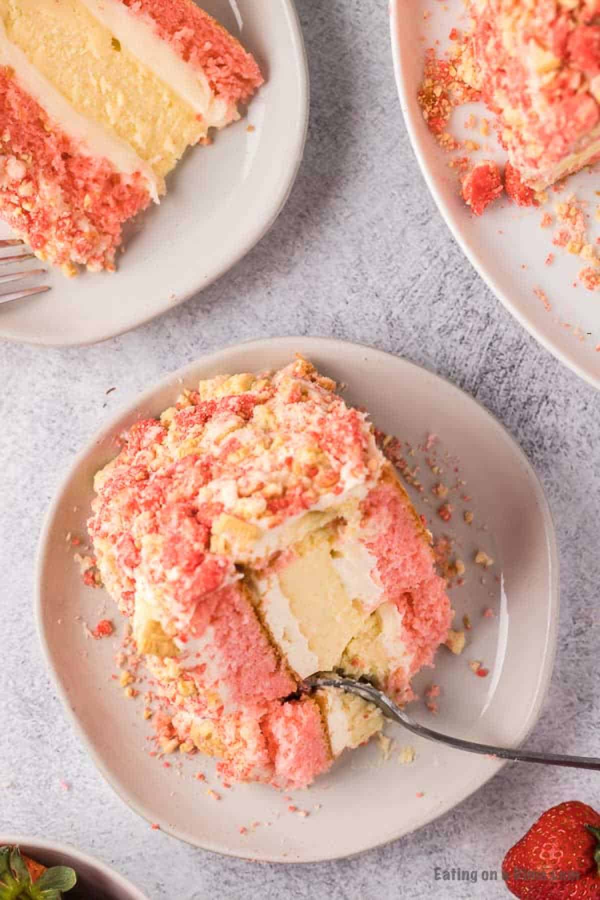 Close up image of a slice of strawberry dessert on a plate.