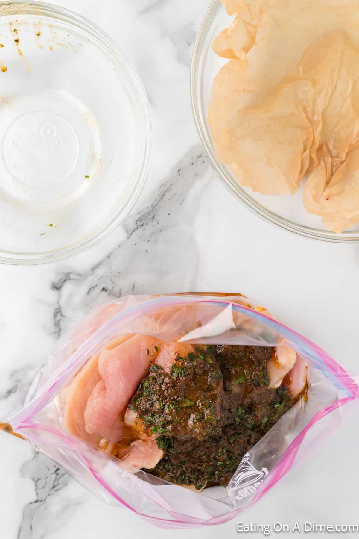 Placing chicken in a ziplock bag with the marinade
