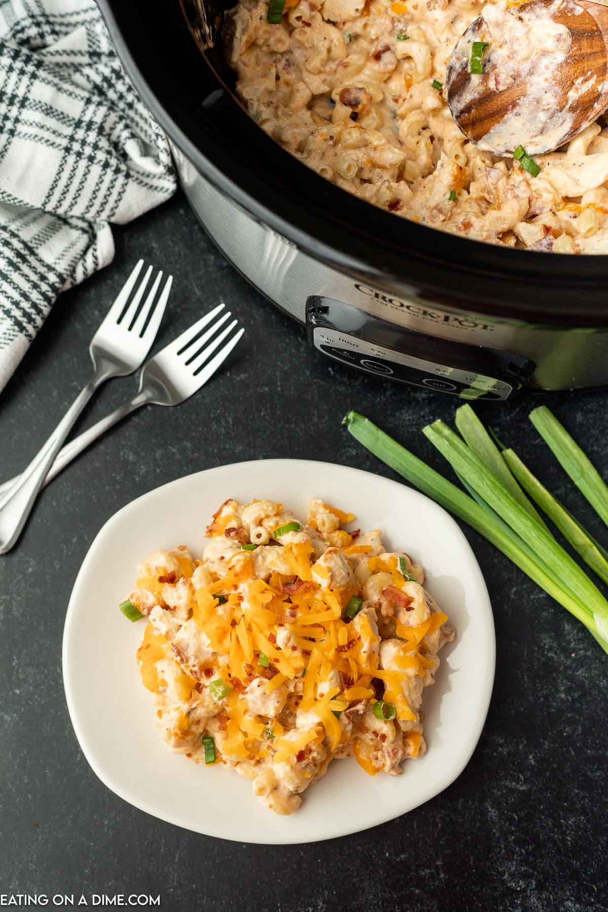 Crack Chicken Casserole on a plate topped with cheese and green onions. 