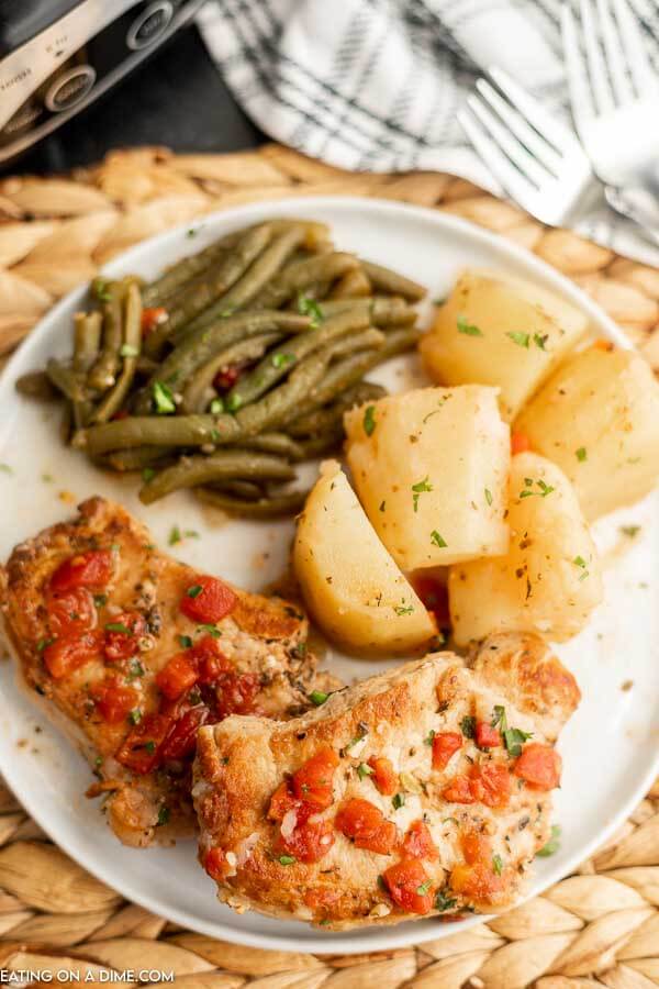 Italian Pork Chops with green beans and potatoes on a plate