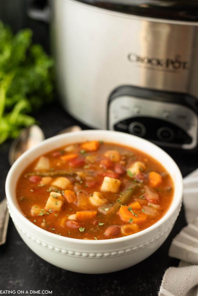 Minestrone soup in a white bowl  with an instant pot in the background