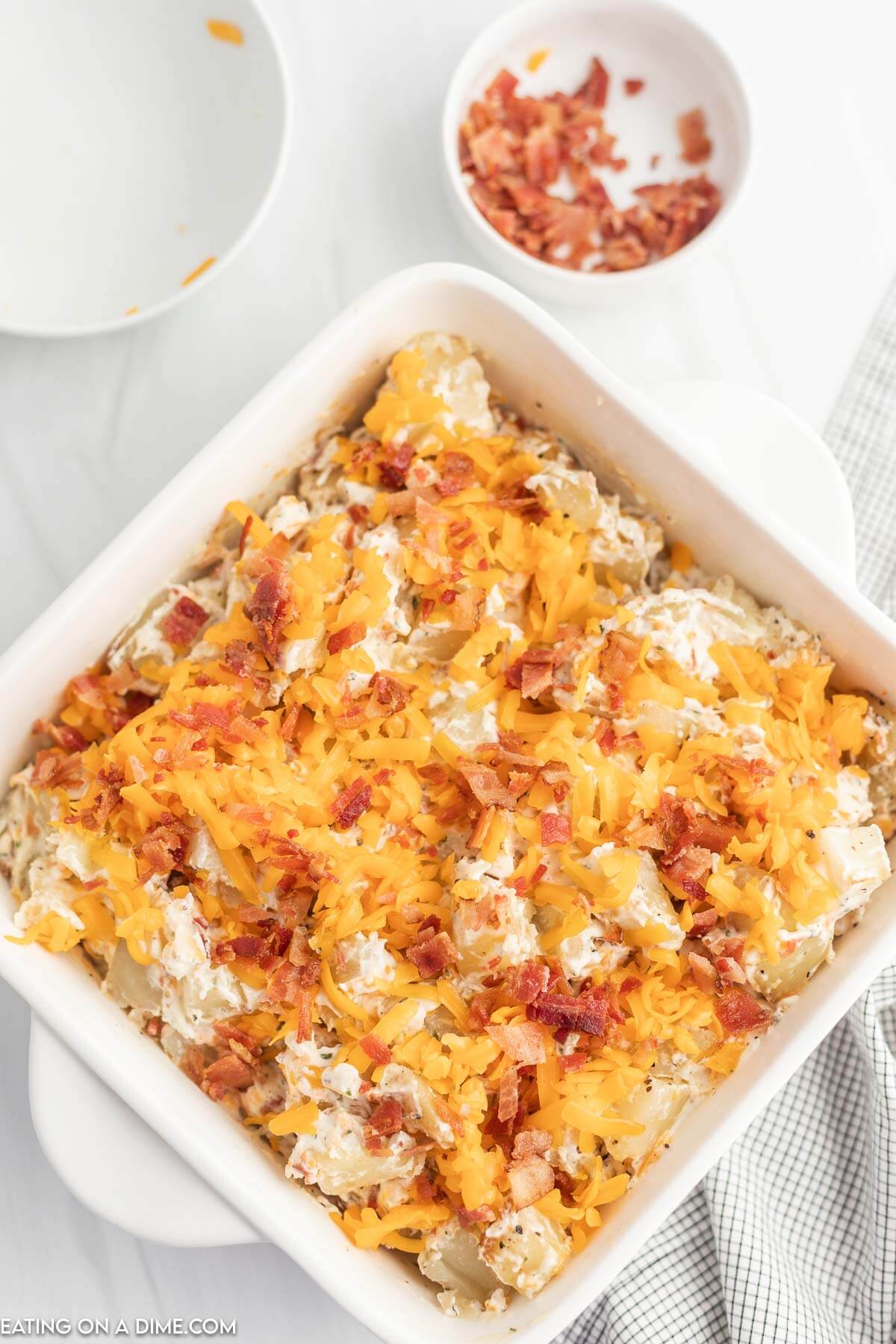 Crack potatoes in casserole dish ready to bake. 