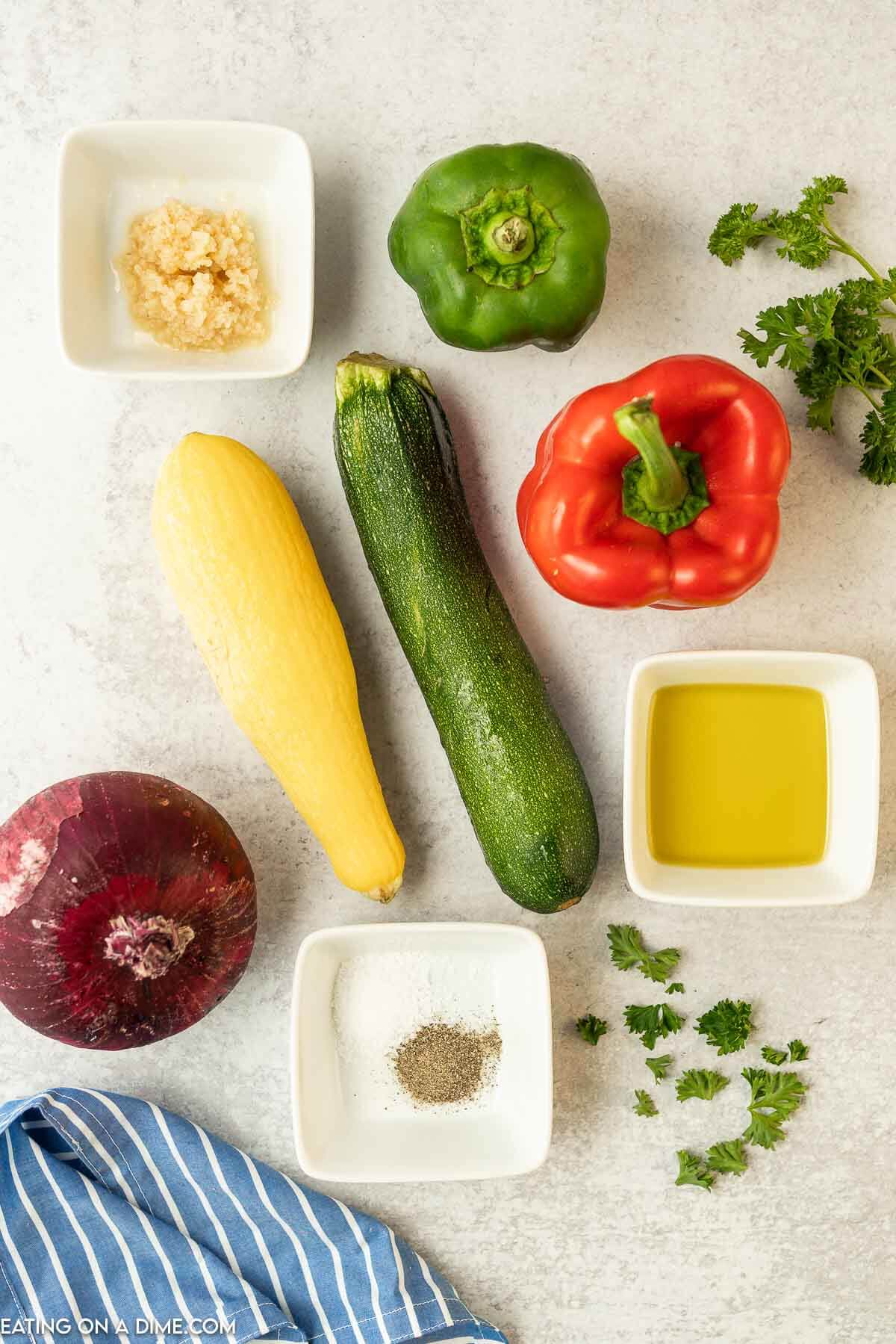 Ingredients for grilled vegetables - zucchini, squash, red onion, bell peppers, salt and pepper, garlic, olive oil