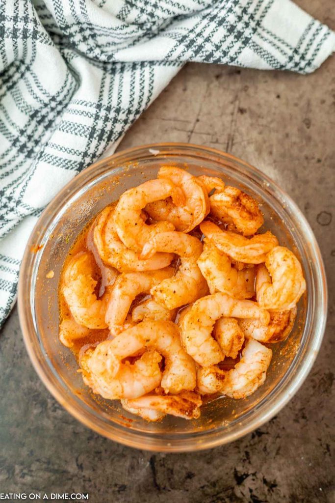 Marinating the shrimp in a large bowl