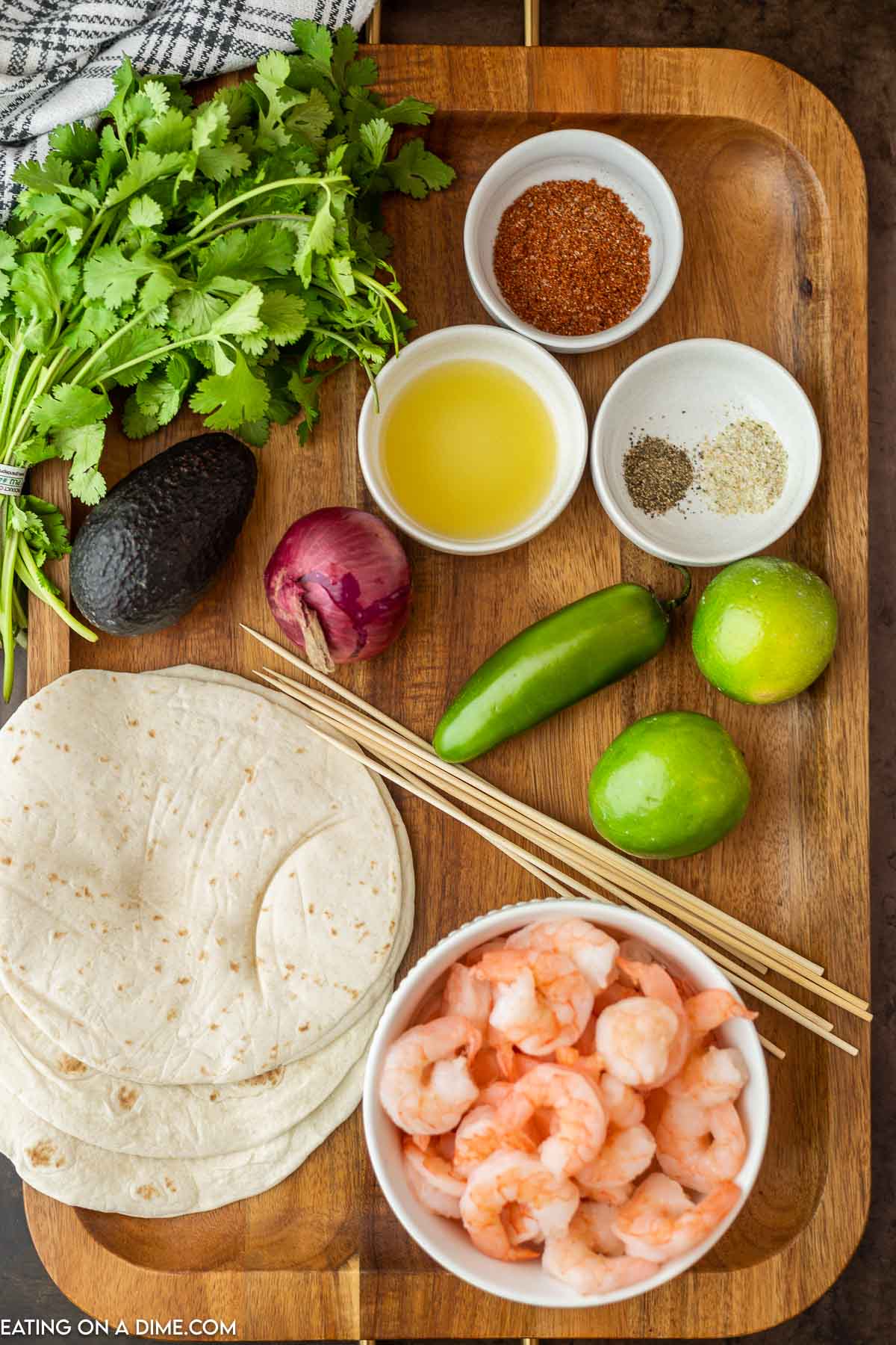 Ingredients needed - shrimp, olive oil, chili powder, cumin, garlic powder, lime, avocado, red onion, jalapeno, cilantro, lime, garlic salt, pepper, skewers, flour tortilla, cojita cheese