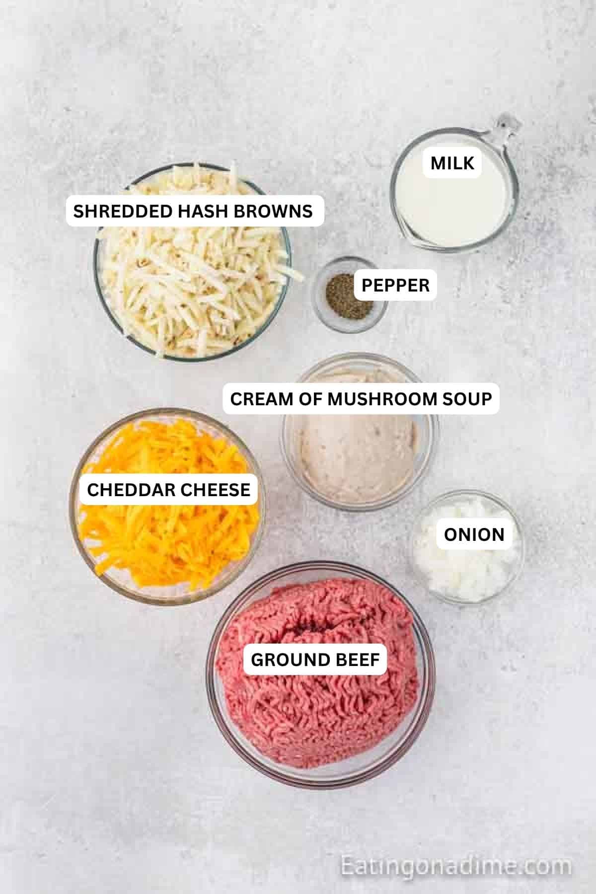 Ingredients for recipe: Shredded hash browns, milk, pepper, cream of mushroom soup, cheddar cheese, onion and ground beef.