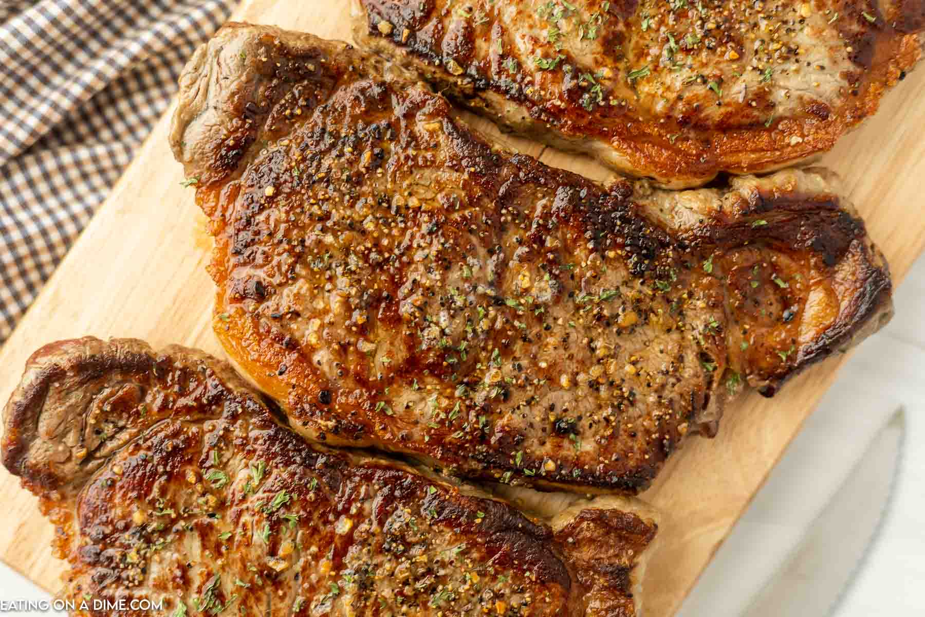 Griddle steak on cutting board. 