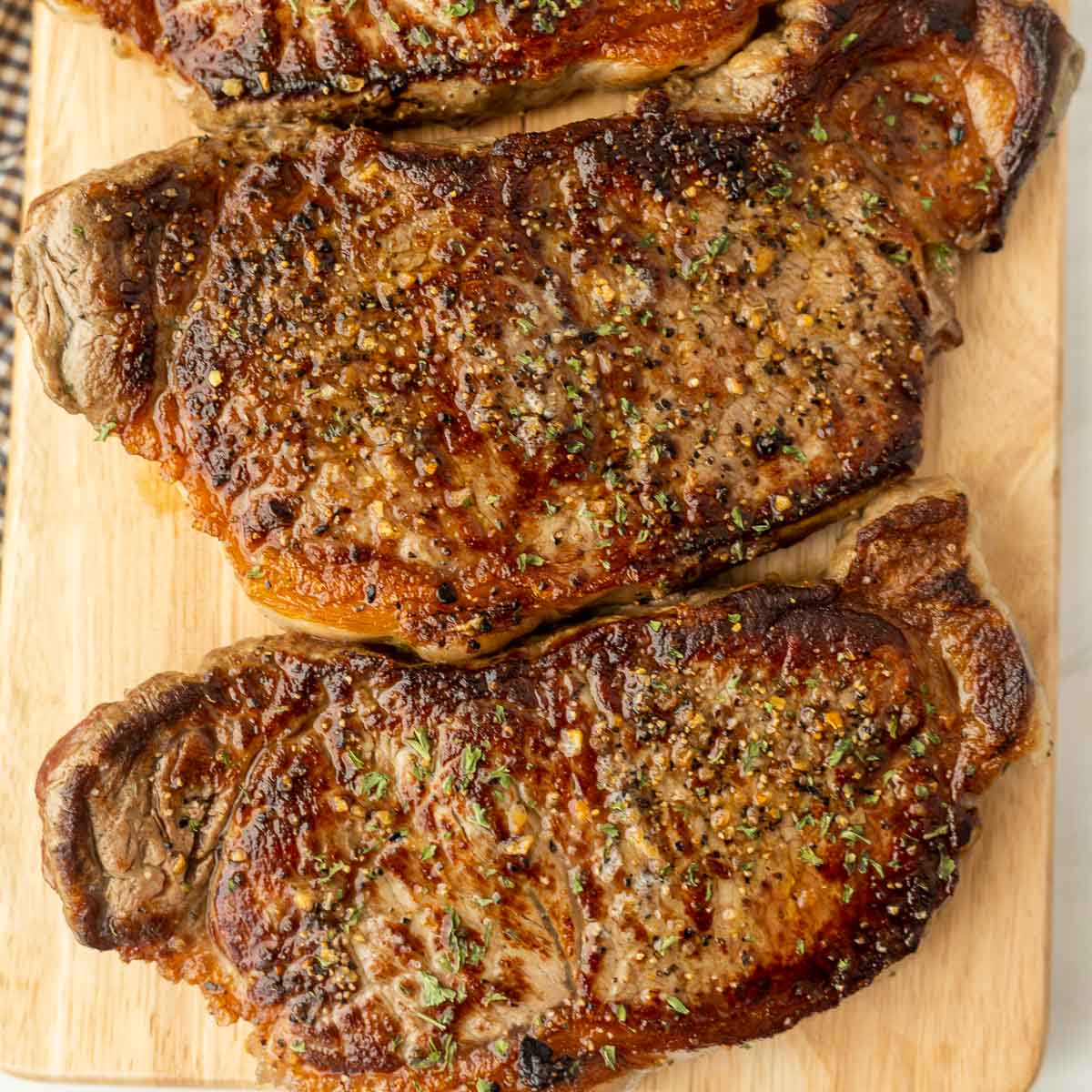 Griddle steak on cutting board. 