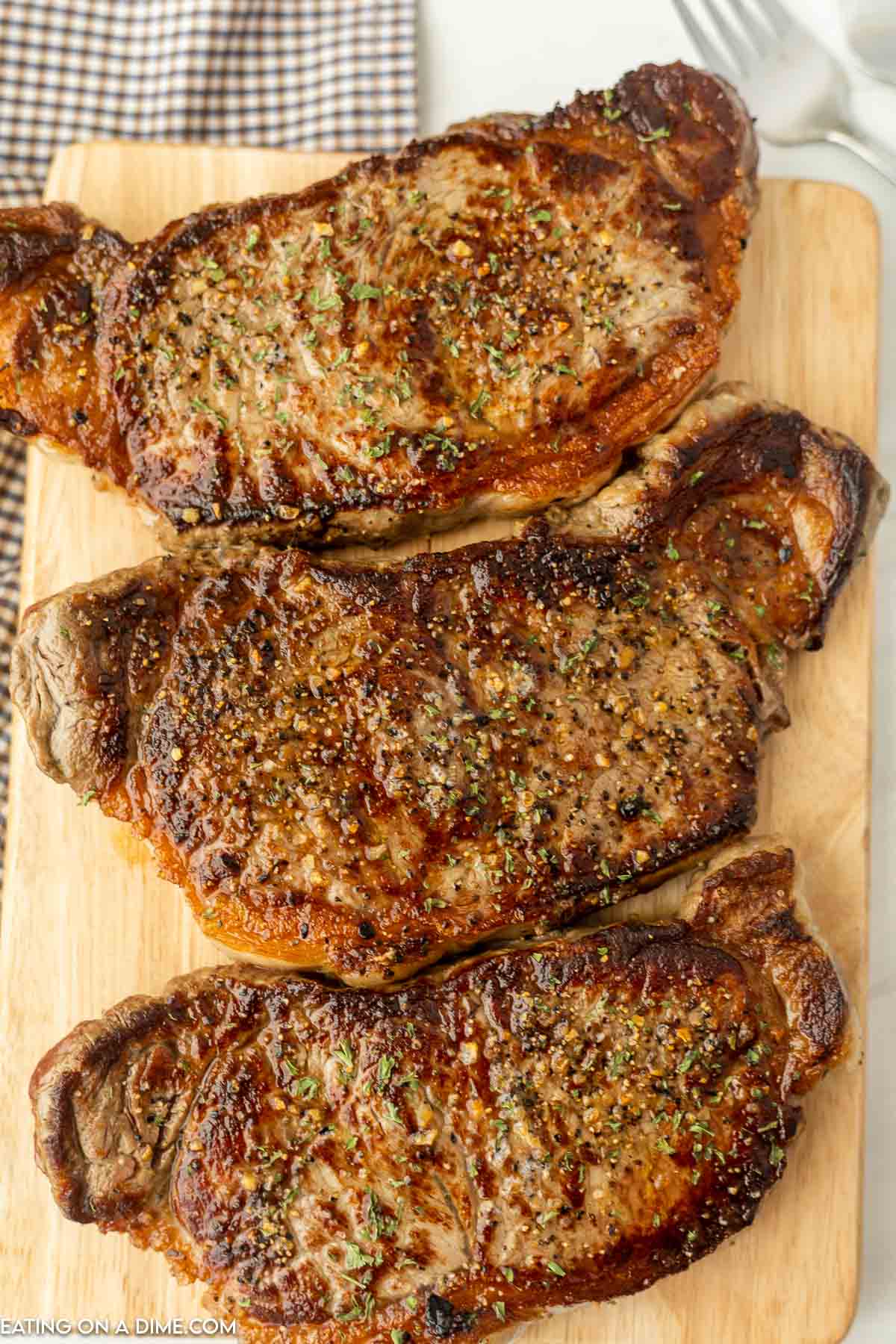 Griddle steak on cutting board. 