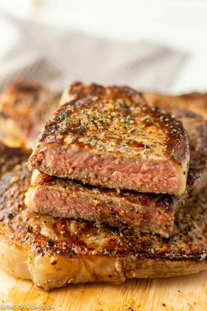 Griddle steak on cutting board. 