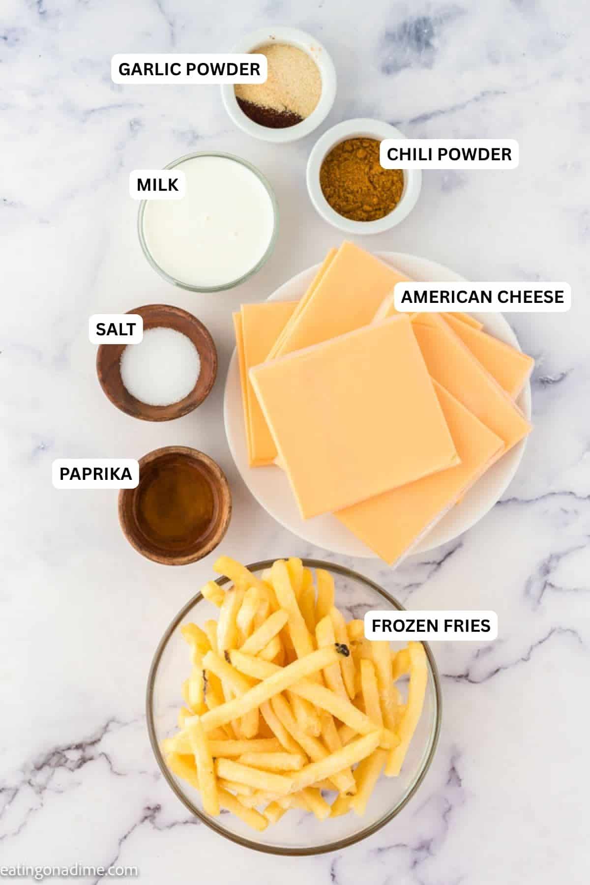Ingredients for recipe: garlic powder, chili powder, milk, American cheeses, salt, paprika and frozen fries.