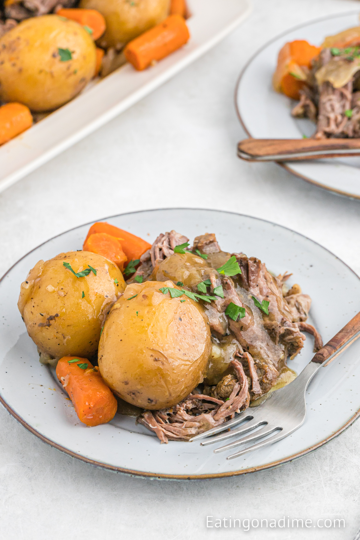 Chuck roast with potatoes and carrots on a plate