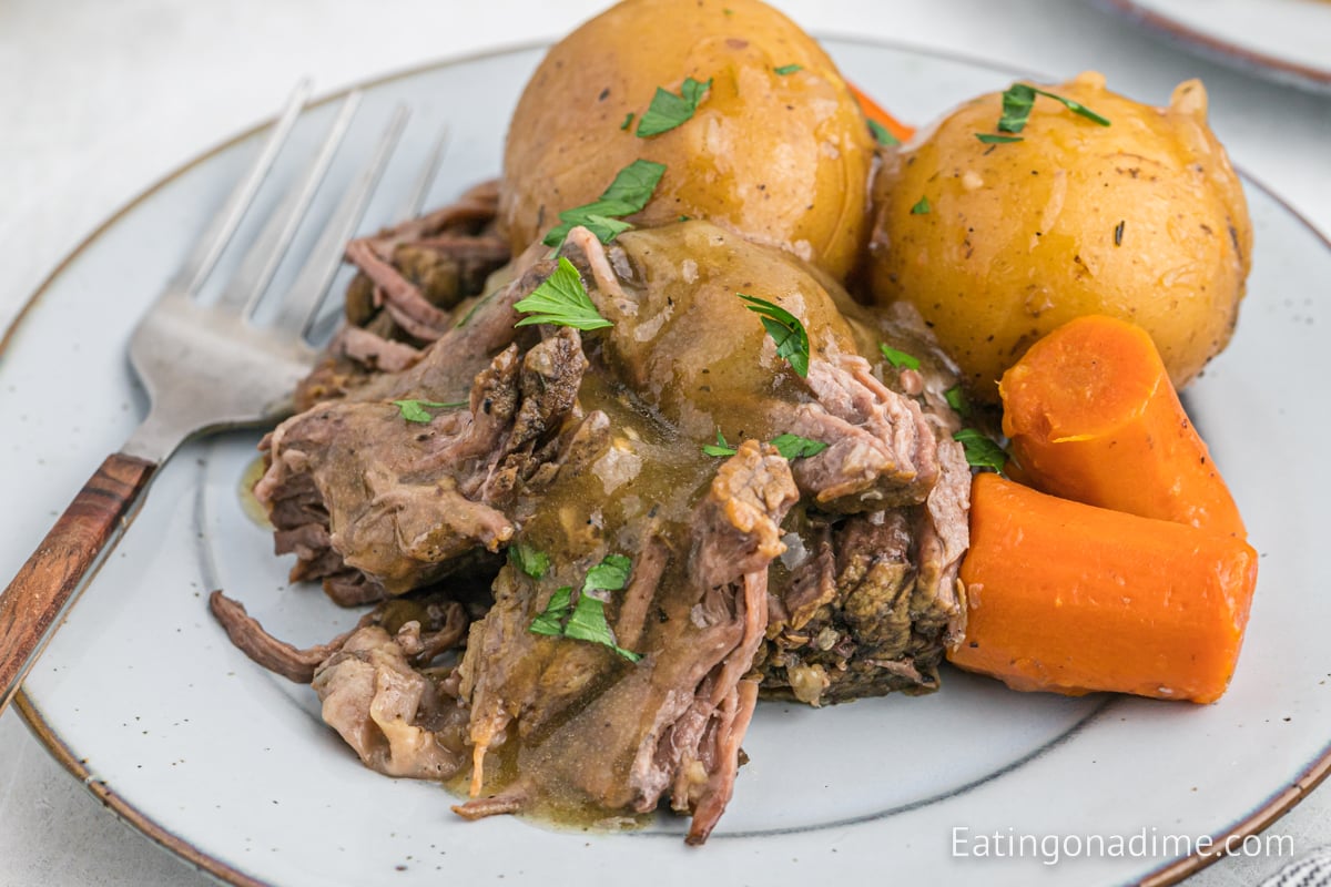 Chuck roast with potatoes and carrots on a plate