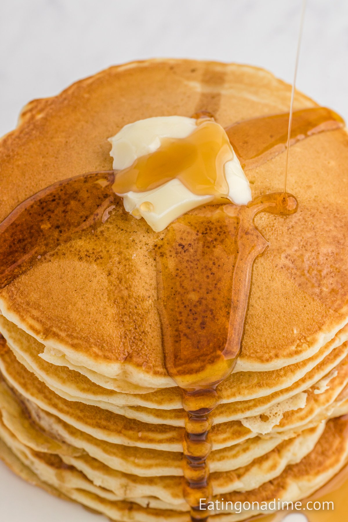 McDonalds pancakes stacked and topped with butter and syrup. 